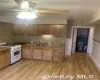 Kitchen featuring gas range gas stove, sink, ceiling fan, backsplash, and light hardwood / wood-style floors