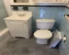 Full bathroom with vanity, toilet, shower / bath combination with glass door, and tile walls