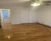 Unfurnished bedroom with ceiling fan, a closet, and light hardwood / wood-style flooring