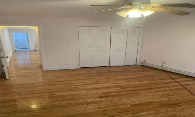 Unfurnished bedroom with ceiling fan, a closet, and light hardwood / wood-style flooring