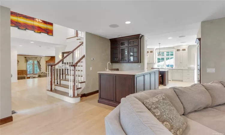 View from Den of Wet Bar, Entrance Foyer, Kitchen Entrance and Formal Living Room