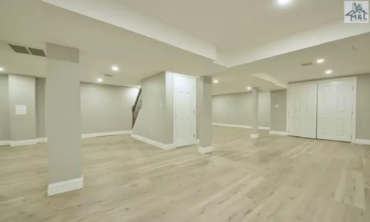 Basement featuring light hardwood / wood-style flooring