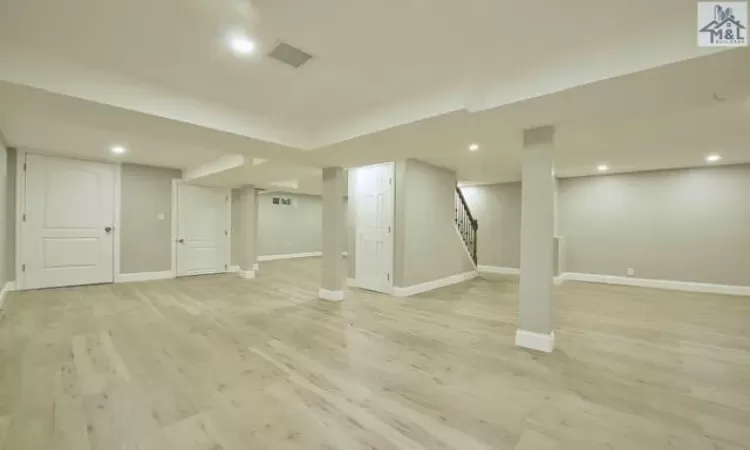 Basement with light wood-type flooring