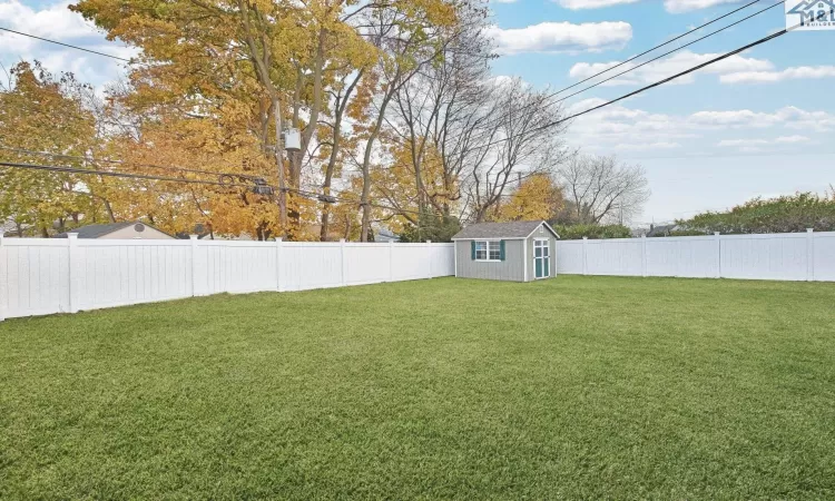 View of yard with a storage unit