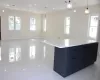 Kitchen featuring light tile patterned floors, decorative light fixtures, a kitchen island, and light stone counters