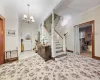 Foyer with a chandelier and ornamental molding