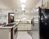 Kitchen featuring backsplash, cream cabinets, sink, and stainless steel appliances