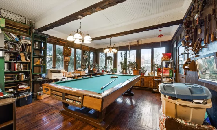 Recreation room with a chandelier, beam ceiling, hardwood / wood-style flooring, and billiards