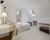 Bedroom featuring lofted ceiling with skylight and light colored carpet