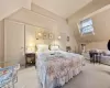 Carpeted bedroom with lofted ceiling