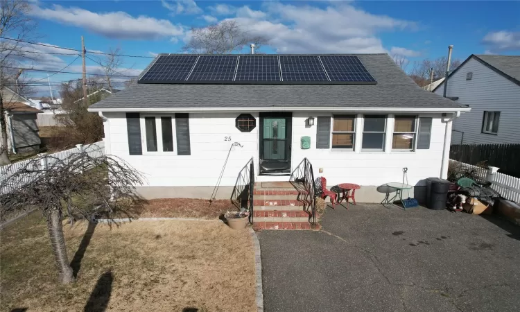 View of front of home featuring solar panels