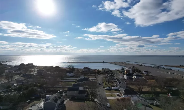 Birds eye view of property with a water view