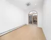 Unfurnished room with light hardwood / wood-style floors and baseboard heating