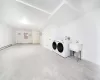 Laundry area with washer and dryer and a baseboard heating unit