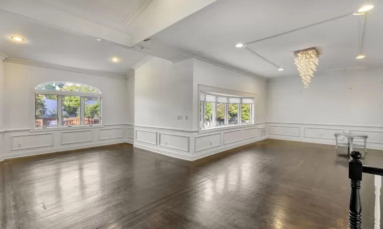 Spare room with plenty of natural light and an inviting chandelier