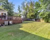 View of yard with central air condition unit and a deck