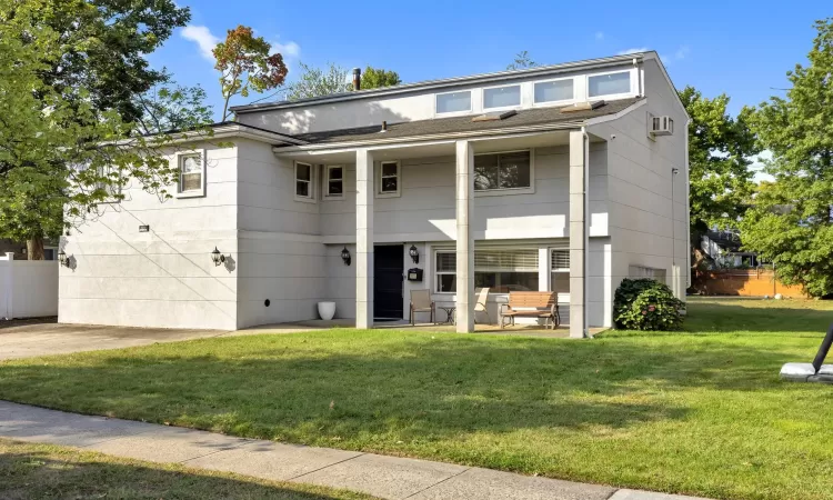 View of front facade featuring a patio and a front lawn