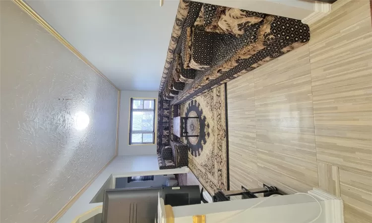 Living room with a textured ceiling and crown molding