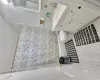 Bathroom featuring tile patterned floors, vanity, tile walls, and toilet