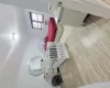 Bedroom with a wall mounted air conditioner and light hardwood / wood-style flooring