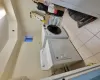 Laundry room featuring cabinets, separate washer and dryer, and light tile patterned floors