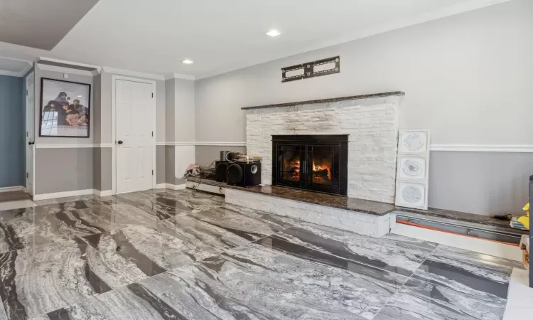 Living room featuring a fireplace and ornamental molding