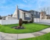 View of front of property featuring a front yard and a garage