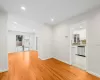 Empty room with light hardwood / wood-style flooring and sink