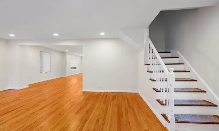 Stairs featuring hardwood / wood-style floors