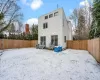 Snow covered house with a wooden deck