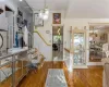 Entryway featuring hardwood / wood-style floors, an inviting chandelier, and ornamental molding