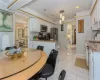 Dining area with ornamental molding, sink, and an inviting chandelier