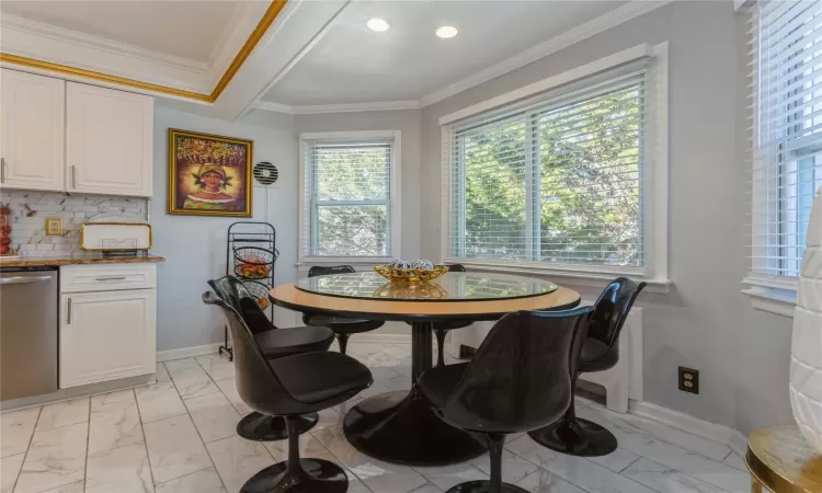 Dining space featuring ornamental molding