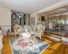 Living room featuring an inviting chandelier, crown molding, and light hardwood / wood-style flooring