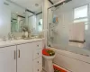 Full bathroom with vanity, toilet, and shower / bath combination with glass door