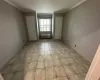 Empty room featuring an AC wall unit and crown molding