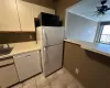 Kitchen with ceiling fan, sink, white appliances, and ornamental molding