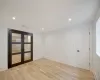 Unfurnished room with light wood-type flooring and french doors