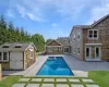 View of pool featuring a patio area and an outdoor structure