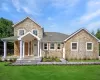 View of front of property featuring a front lawn and covered porch