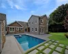 View of swimming pool with an in ground hot tub, a patio area, and a lawn