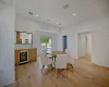 Dining space featuring light hardwood / wood-style floors, beverage cooler, and sink