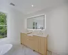 Bathroom featuring a bathing tub, plenty of natural light, and vanity