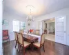 Dining area featuring dark hardwood / wood-style flooring, ornamental molding, french doors, and a chandelier