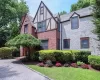 Tudor-style house with a front lawn