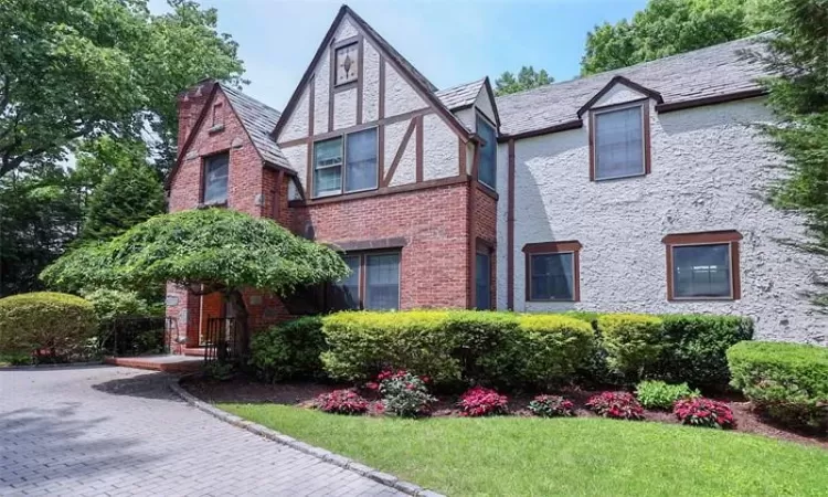 Tudor-style house with a front lawn