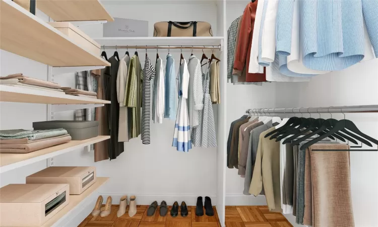 Walk in closet featuring parquet flooring