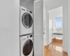 Clothes washing area featuring stacked washer and dryer