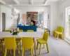 Dining room with beamed ceiling, plenty of natural light, light wood-type flooring, and a fireplace