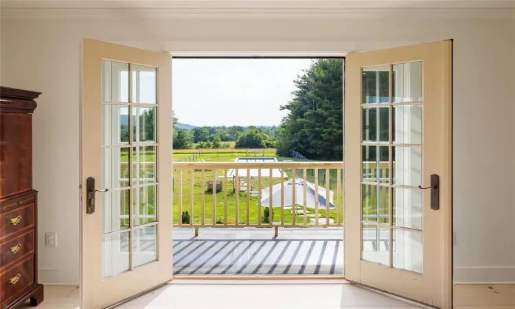 Entryway featuring french doors and crown molding